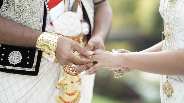 On their wedding day, the couple lovingly exchange rings, shows their commitment and love.