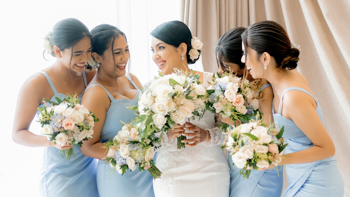 On their dream wedding day, the bride and her joyful bridesmaids share laughter and happiness, making perfect moments of real happiness.