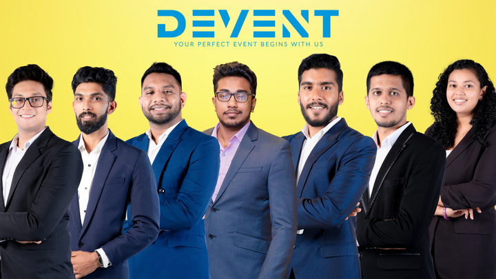 Team Devent: A group of 7 professionals in formal attire under the Devent logo with the slogan "Your Perfect Event Begins With Us" on a yellow background, Mangla yojana 2024, matrimony sri lanka, sl marriage proposals, mangala yojana, marriage proposal in sri lanka, Sri Lankan matrimony, Sri Lankan marriage proposal sites.