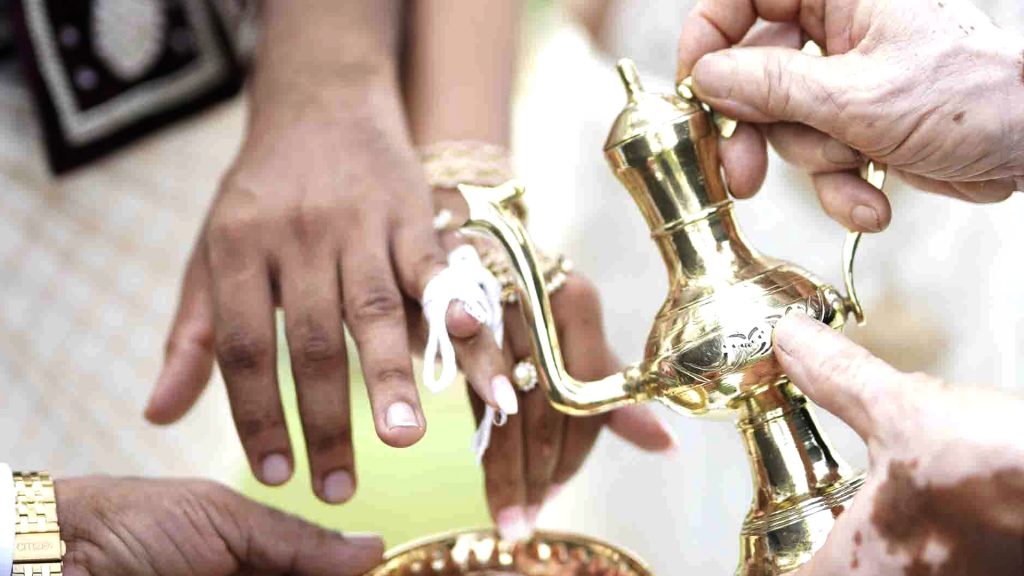 two fingers of the bride and groom is tied on their wedding day which is a Sri Lankan tradition