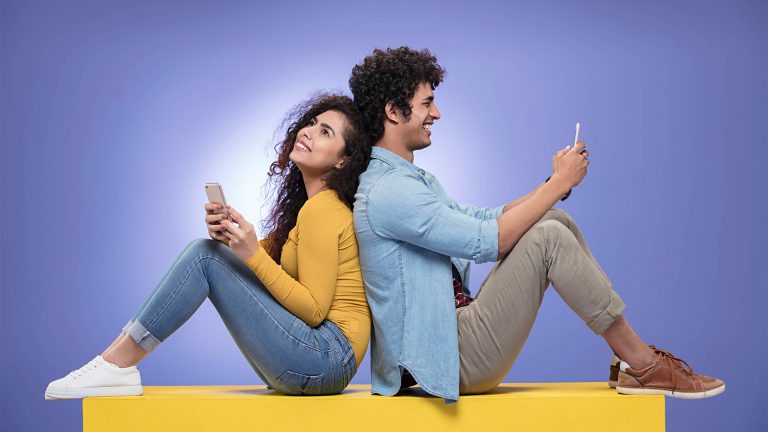 A man and woman seated side by side, looking at a laptop screen, possibly collaborating on a project or task- mangala kinkini, mangala yojana,sri lankan matrimony,sri lankan bride, marriage proposal in sri lanka, Mangala sewaya,