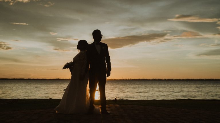 A professional wedding photographer in Orlando, Florida capturing a couple’s romantic moments with a scenic outdoor backdrop, perfect for wedding photography memories.