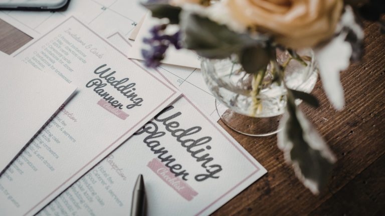 Wedding planner notebook and pen on a wooden table, used for planning Sri Lankan weddings and marriage proposals on Poruwa.lk.